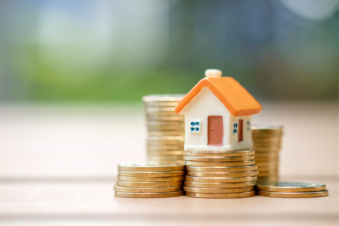 Small model house on stack of coins money 01